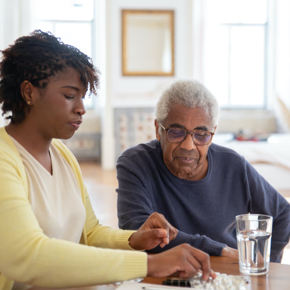 CNA guiding a resident with medication.