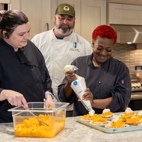 Several Immanuel culinary team members prepare desserts.