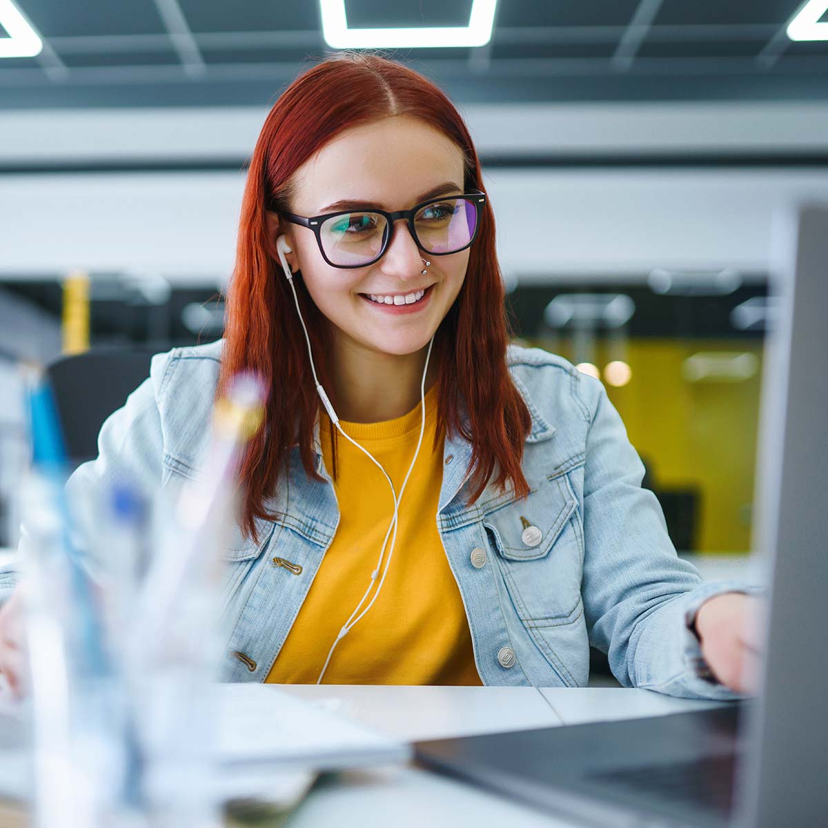 An Immanuel intern smiles while working on her computer.