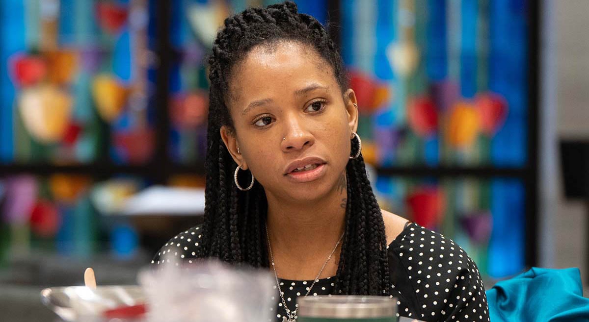 A leader first attendees talks with group members at her table.