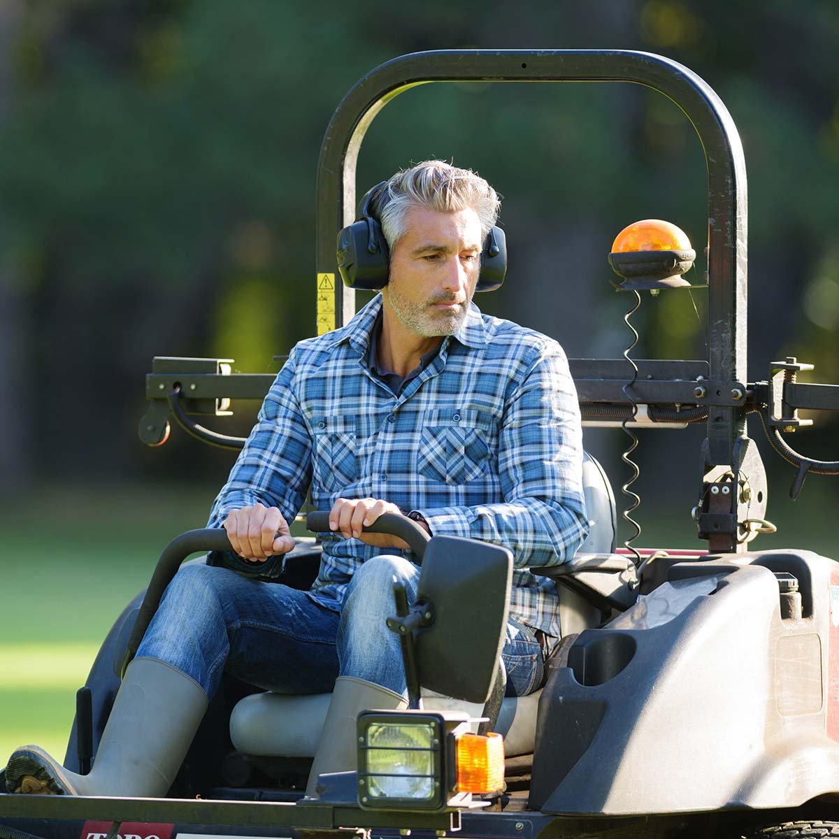 An Immanuel maintenance worker mowed grass on a large lawnmower.