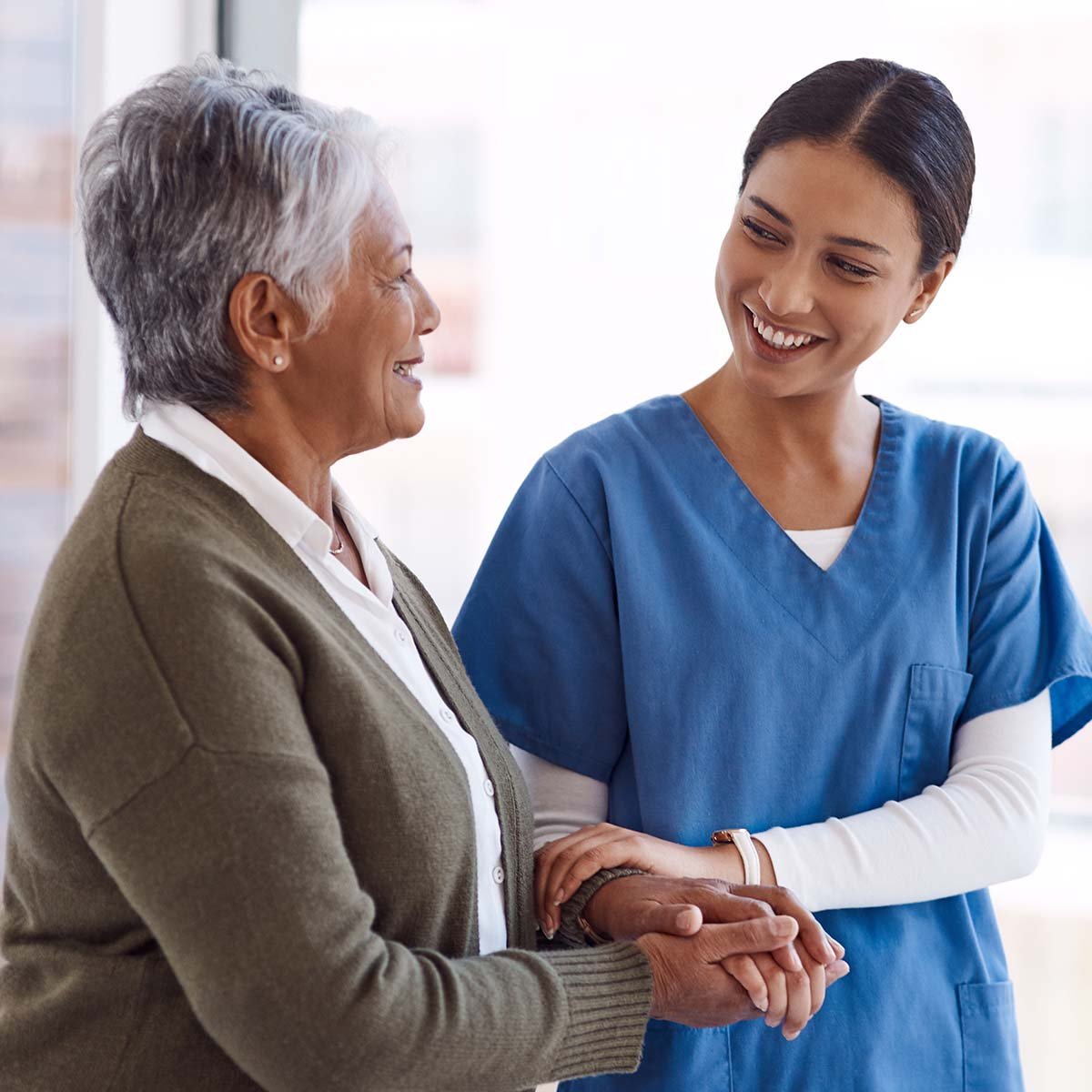 Nurse walking with a senior patient.