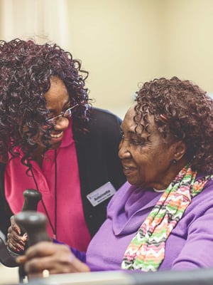 An Immanuel Pathways employee speaks with a PACE® participant as they are exercising. 