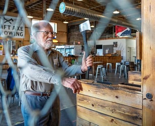 A resident lines up to throw an axe during an Immanuel Adv