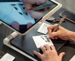 Close-up view of a seniors hands drawing shapes.